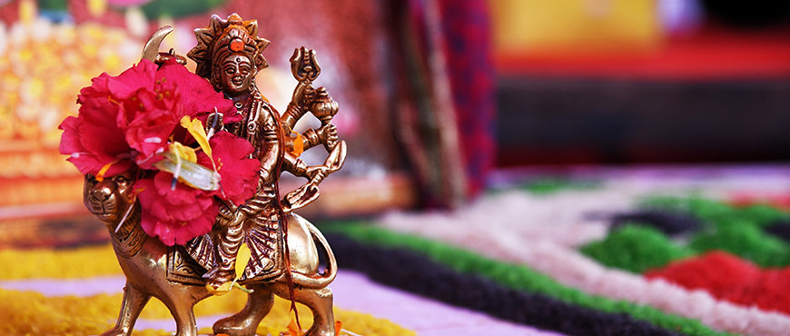 Goddess Durga golden statue with red flower - Navratri 2022
